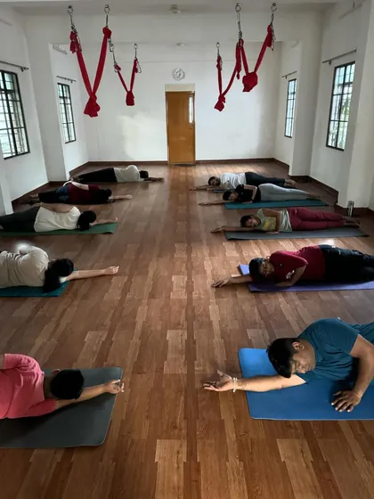 Students resting in a gentle twist during our Yin Yoga session. These passive stretches help release deep-seated tension in the body.
