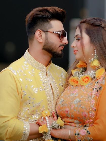 An intimate portrait of the couple, their gazes locked, showcasing their beautiful floral jewelry and the love between them.