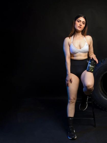 A similar pose to the previous shot, but with the model facing the camera. This provides an alternative angle for marketing campaigns, offering variety while maintaining a consistent, high-end aesthetic for the supplement brand.