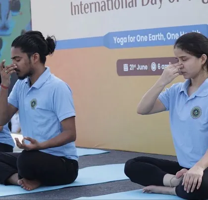 My team leading a pranayama session from the stage, demonstrating calming breathing techniques to the event attendees.