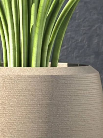 A close-up view of the texture on one of our polymer planters. The subtle horizontal lines add a touch of handcrafted detail to the clean, modern shape.