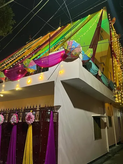 The wedding home decor looks spectacular at night with all the lights turned on. The colorful drapes and fairy lights create a truly festive look.