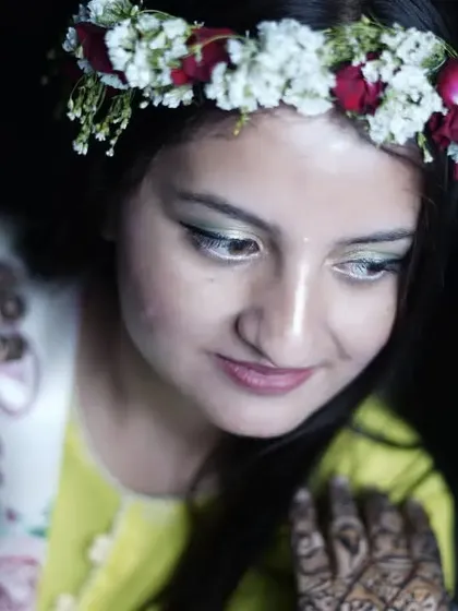 A close up, high-angle shot of the bride looking down, giving a lovely view of her floral crown and "Bride to Be" sash.