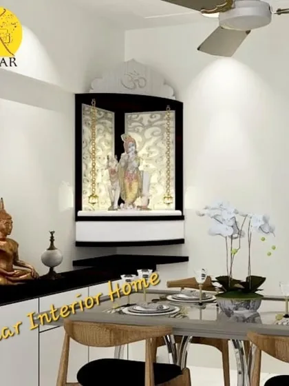A compact, wall-mounted corner pooja unit in black and white. This space-saving design is perfect for smaller apartments in Mumbai and features elegant chains and backlighting.