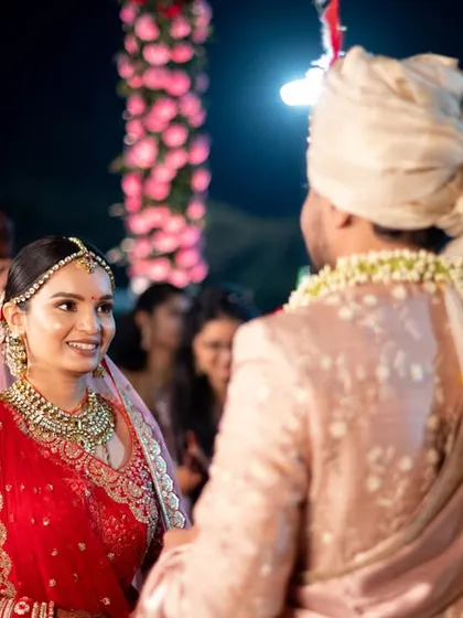 A candid moment of the bride and groom looking at each other during their Gujarati wedding.