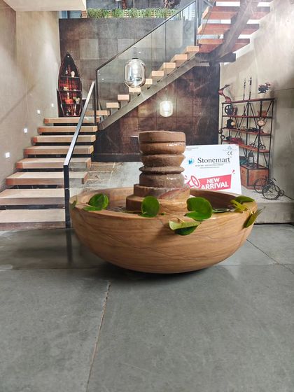 This view shows the scale of the lotus pond fountain against a modern staircase, illustrating how it can complement interior architecture.