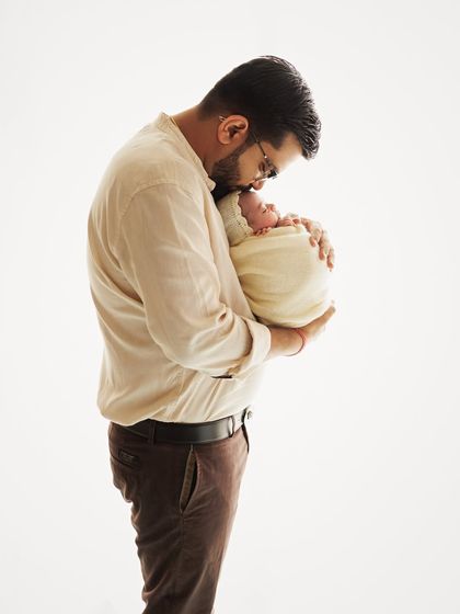 A different angle of a father's kiss, showing the pure love and gentleness in the gesture.