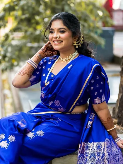 The details of the blue Nauvari and the soft, glowing makeup that enhances her beautiful smile.