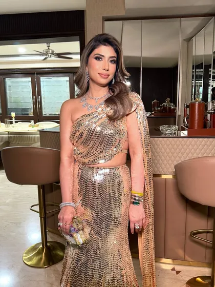Dazzling in a stunning Manish Malhotra gown. The makeup is pure glamour, with a defined eye and glowing skin that makes every moment shine brighter.