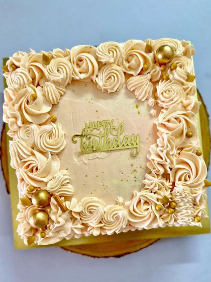 Another angle of the tropical pineapple and coconut cake, showing the detailed piping work around the border.