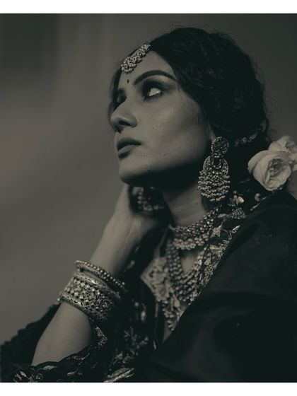 Another perspective of this vintage bridal look, with a white rose tucked into her hair. The contrast of the soft flower against the heavy silver jewelry creates a beautiful balance.