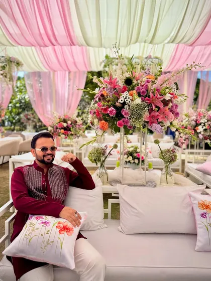 Taking a moment to soak in the beautiful floral decor at a wedding in Jim Corbett. The right ambiance is key to setting the tone for a great event.