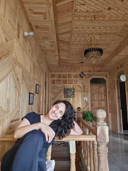 A happy moment at my mountain home. The traditional wooden interiors and the feeling of being nestled in the hills create a sense of unparalleled peace and contentment.