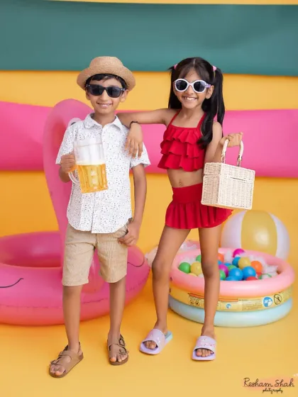 This brother-sister duo is ready for a summer party! Their coordinated outfits and cool shades make for a super stylish and fun themed shot.