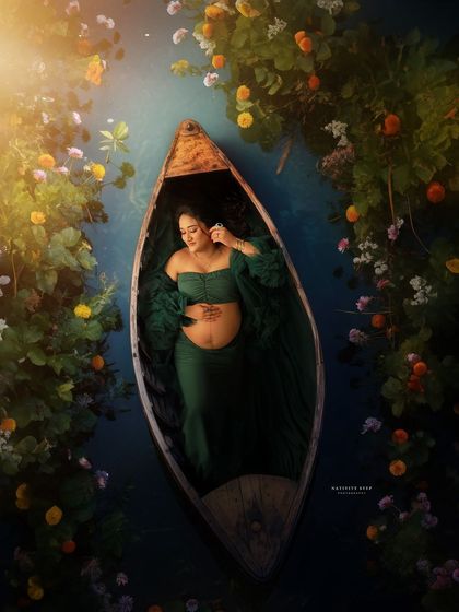 A variation of our creative boat concept. This overhead shot captures the mother-to-be peacefully resting in a boat, surrounded by a floral wonderland.