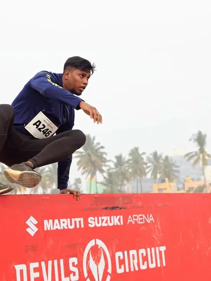 An obstacle course race is about explosive power and agility. This is me clearing a wall jump at the Maruti Suzuki Devil's Circuit. We practice these movements, focusing on technique and efficiency, so you can vault over walls without wasting energy.
