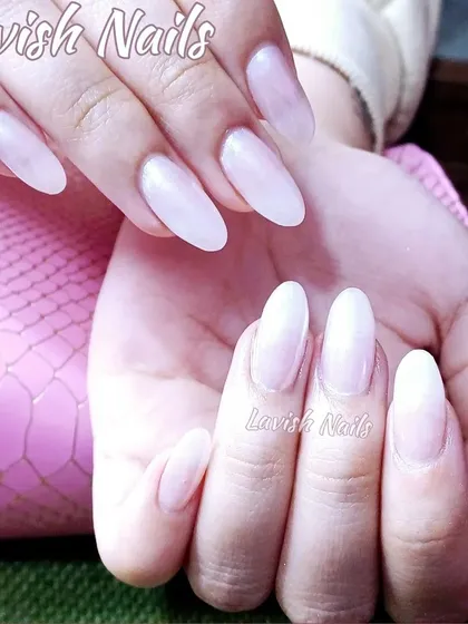 A beautiful set of milky white almond-shaped nails for a clean and polished look.