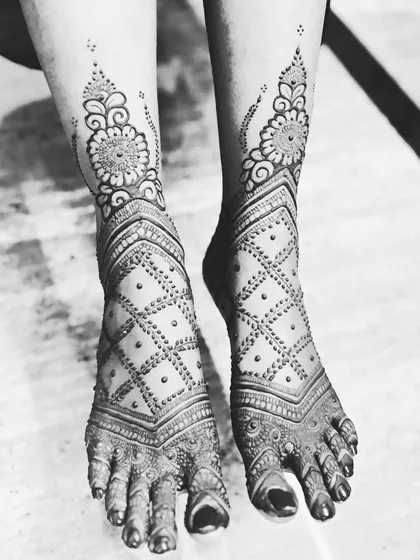 A black and white photo of this geometric leg design. The sharp lines of the checkerboard pattern and the floral cuff look so striking.