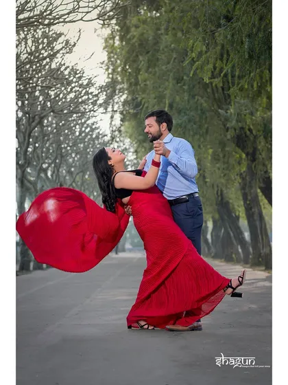 A classic Bollywood twirl! The vibrant red saree in motion against the lush green backdrop creates a beautiful, high-energy shot that’s full of life and romance.