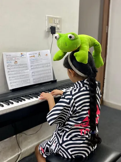 Who said learning proper posture can't be fun? Meet Mr. Frog, our little helper in piano classes. This simple challenge helps our youngest students maintain correct hand and body posture while they focus on their music.