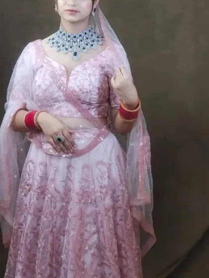 This light pink embroidered lehenga is a great option for a day function. It's paired here with a modern blue-stoned American diamond necklace.