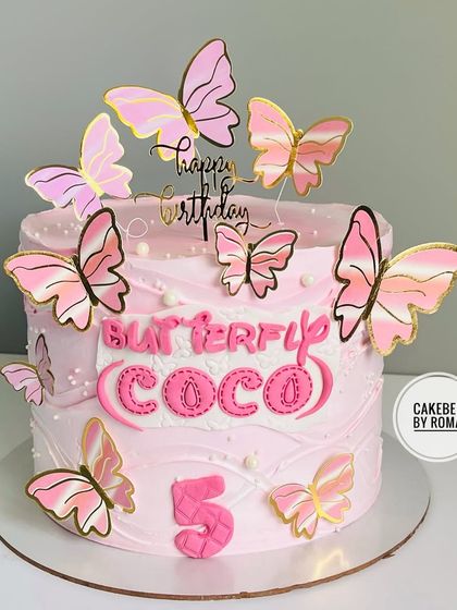 A lovely pink butterfly-themed cake for Coco's 5th birthday. The design features delicate pink and gold butterflies that seem to flutter around the cake.