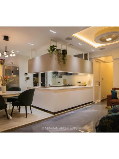 The open-plan layout of the Bhagwati Greens project, showing the kitchen island, dining table, and living area all in one harmonious space. This design is perfect for modern family living.