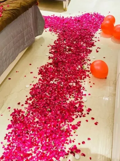 A close-up of the romantic pathway we create using fresh rose petals and small tea light candles, leading the way to the main surprise.