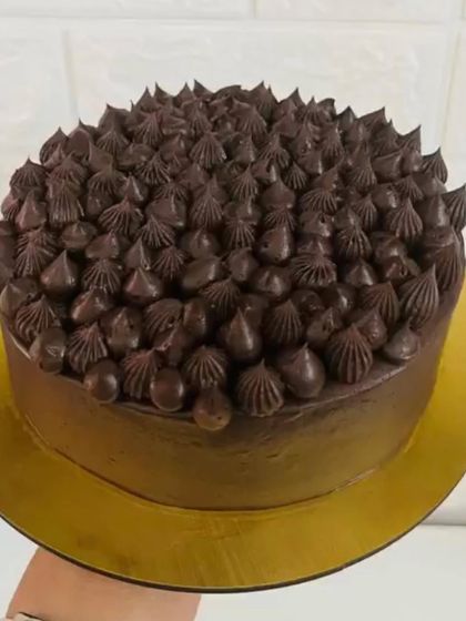 For the ultimate chocolate lover, this cake is covered in rich chocolate frosting and topped with dozens of chocolate drops and stars for an intense chocolate experience.