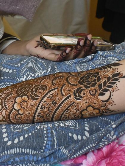 A full forearm design for bride Asba, featuring a beautiful blend of floral and vine patterns.