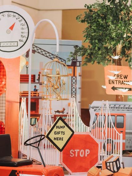 A wide array of construction-themed props, including traffic signs, a toy tractor, and a 'Dump Gifts Here' sign, creating a fun and cohesive look.