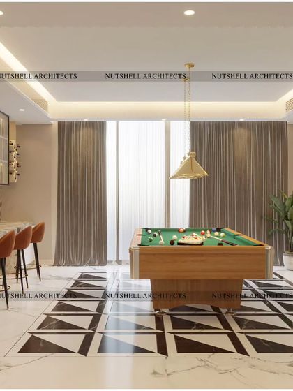 This ultimate billiards room is designed for stylish entertaining. It features a sleek marble-topped bar with comfortable seating, set against a backdrop of bold, geometric black and white marble flooring.