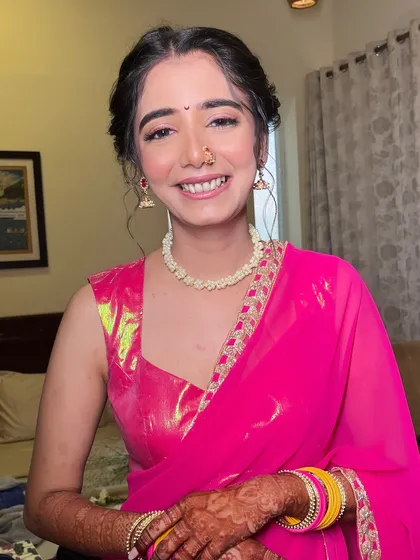 The complete look for this beautiful Haldi ceremony. The makeup is light and radiant, perfect for a daytime event.