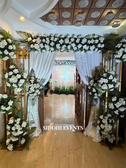 An entrance defined by pure elegance. We used flowing white curtains and a gate completely enveloped in pristine white florals to create an enchanting and dreamy passageway.