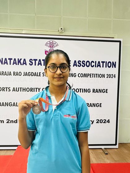 Aadhyalakshmi with her gold medal from the Air Rifle Women's team event.