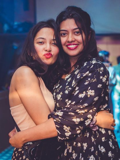 Friends hugging and posing for a photo, making memories.