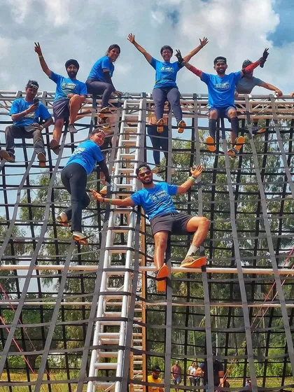 Getting a different perspective from the top of a Spartan obstacle. It’s not just about running; it’s about facing challenges, helping each other over walls, and enjoying the view from the top.
