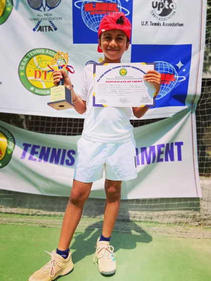 A proud Aariv Gupta holding his trophy and certificate after his successful run at the NCR School Tennis Talent Championship. We will keep working hard to support his future endeavors.