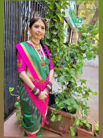 A full Tamil Iyer bridal makeover, showcasing the vibrant green and pink Madisar saree. As a makeup artist and drapist, I can create the entire look, ensuring every detail is perfect.