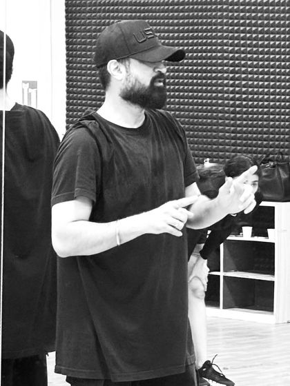 A focused moment during a rehearsal. As a coach, I pay close attention to the details to ensure the final performance is polished and powerful.