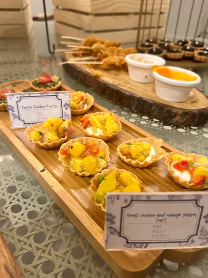 These are our goat cheese and mango salsa tarts, a unique and flavorful appetizer. The combination of creamy cheese and sweet, tangy salsa in a crispy tart shell is always a crowd-pleaser.