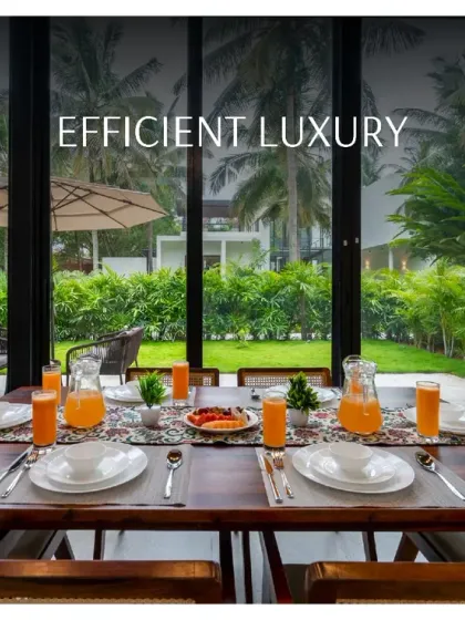Efficient luxury is my promise. This image captures the dining area of the M Villa, where a beautifully set table looks out onto a manicured garden through floor-to-ceiling glass walls.