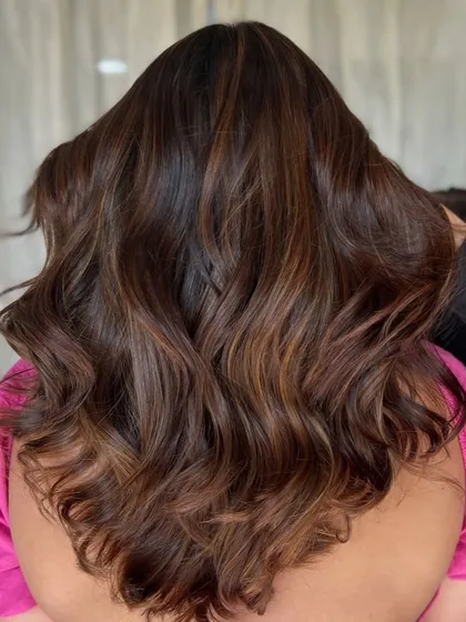 The back view shows how the caramel highlights are concentrated through the mid-lengths, creating a beautiful contrast with the darker base colour.