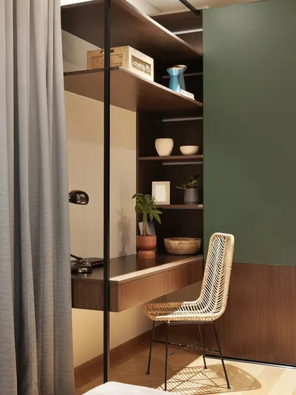 Another angle of the study nook, showing how it is neatly tucked beside the wardrobe, maximizing the use of space.