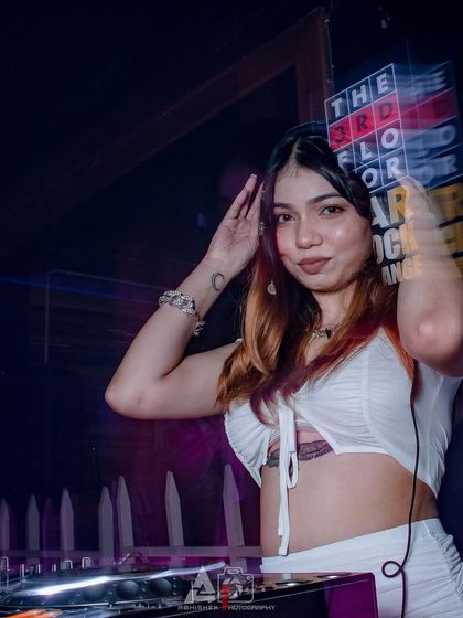 Adjusting my headphones to cue up the next track. It's all about seamless transitions and keeping the flow of the party going.