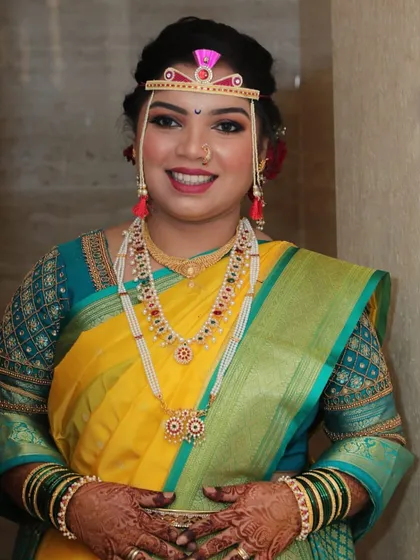 A smiling portrait of the bride, looking radiant and ready for her wedding rituals.