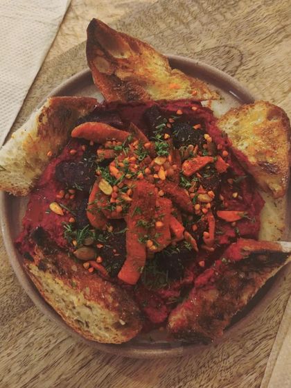 Our beetroot hummus served with sourdough heels. A vibrant, flavorful, and zero-waste dish.