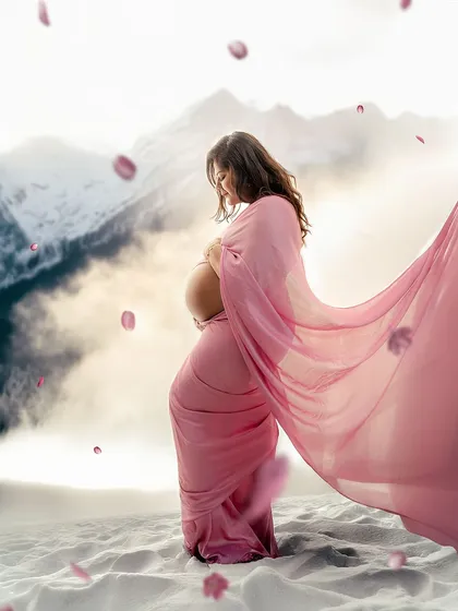 A winter wonderland of pink. This composite image places the mother-to-be in a snowy landscape with a flowing pink gown, creating a magical and unique fantasy portrait.