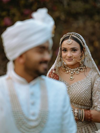 A creative over-the-shoulder shot of the bride looking at her groom, creating a sense of anticipation and romance.