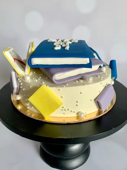 Another angle of the book lover's cake, showcasing the detailed sugar work.